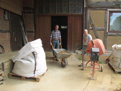 Uwe und Harry vermengen Lehmpulver und Innenputzsand zu Lehmunterputz
